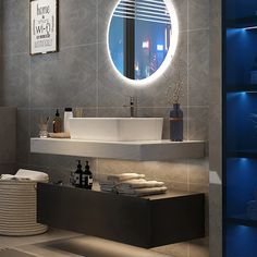 a bathroom with a round mirror above the sink and lights on the wall behind it