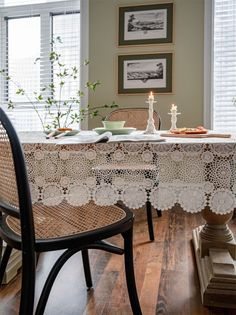 a table with two chairs and a lace doily on it