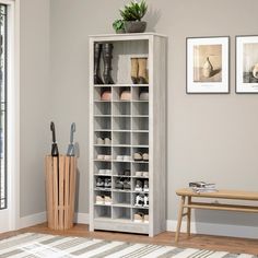 a white bookcase filled with shoes next to a wooden bench and potted plant