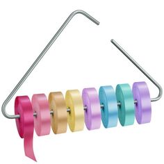 several rolls of colored tape hanging from a metal hook