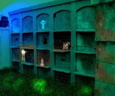 an abandoned building with green grass and blue light