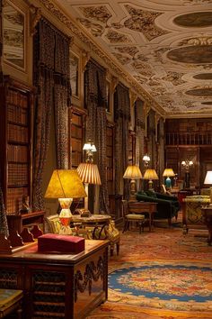 a living room filled with lots of furniture next to tall bookshelves and lamps