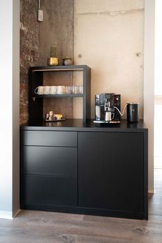 a coffee bar with shelves and cups on the top shelf in a room that has exposed brick walls