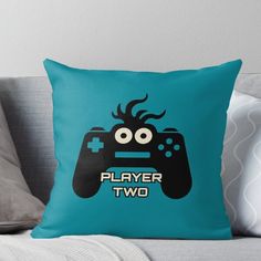 a blue pillow with a video game controller on it that says player two in the center