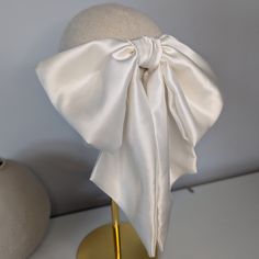 Handmade in Kate's Limerick studio in Ireland, using a weighted 22 momme 100% silk material, this hair bow is the epitome of style and grace.  This bow is oversized, draping beautifully as it sits on the head. Secured with a robust French barrette clip, once is place, this bow is going nowhere. Sucha stylish, statement piece for a bride to be or even if you just want to add a bit of glamour to your smart/casual attire. Check out my Etsy store for more luxury hair accessories. Going Nowhere, Luxury Hair Accessories, Bow Accessories, French Barrette, Luxury Hair, Satin Bow, Silk Material, Style And Grace, Barrette Clip