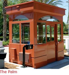 an orange public phone booth with palm trees in the background