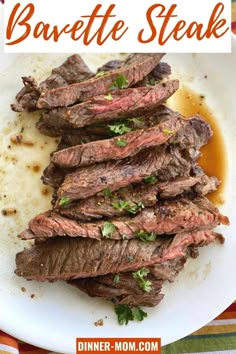 grilled steak on a white plate with sauce and parsley garnishes