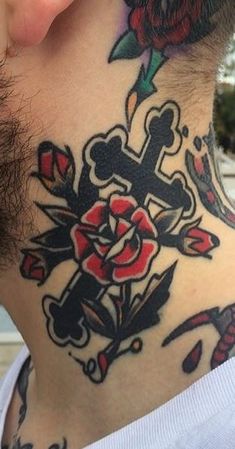 a man with a cross and rose tattoo on his neck