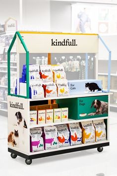 a pet store display with dog and cat products on it's shelves, including an animal food stand