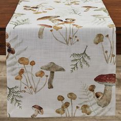 a table runner with mushrooms and plants on it