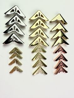 five different types of metal trees on a white surface