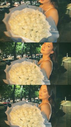 a woman holding a bouquet of white roses