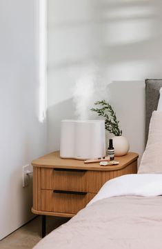 a bedroom with a bed, nightstand and air humider