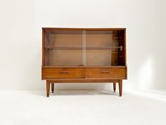 a wooden cabinet with glass doors and drawers