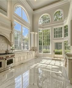 a large kitchen with marble floors and white cabinets