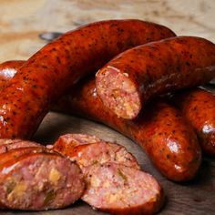 several sausages on a wooden cutting board