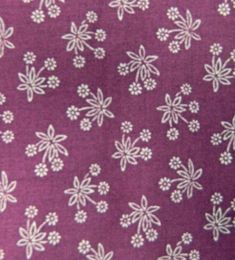 a purple background with white flowers and leaves on it's side, as well as the bottom half of the fabric