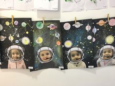 three pictures of babies in space hanging on clothes pins