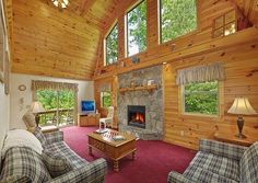 a living room filled with furniture and a fire place in the middle of a room