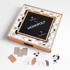 an unopened monopoly board game with its contents laid out