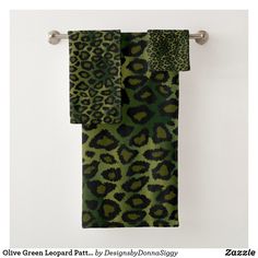 green and black animal print towels hanging on a towel rack