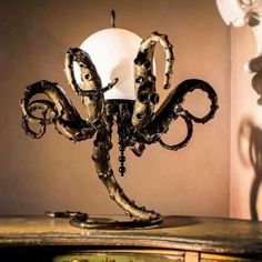 an octopus lamp sitting on top of a wooden table next to a white light bulb