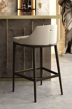 a modern bar stool in front of a counter with bottles and wine glasses on it