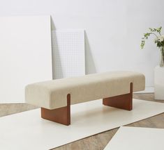 a bench sitting on top of a white rug