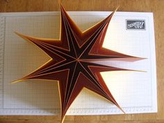 an origami star on top of a piece of paper