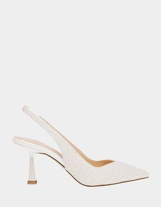 a pair of white high heels with glitter on the heel and pointed toed toes