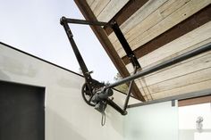 an outdoor shower area with a wooden roof and metal fixtures on the side of it