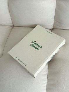 a book sitting on top of a white couch