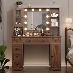 a wooden vanity with lights on it next to a bed