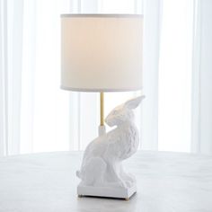 a white rabbit lamp sitting on top of a table