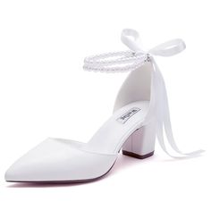 a pair of white shoes with pearls on the heel