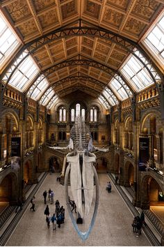 the interior of a museum with people walking around