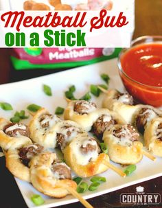 meatball suk on a stick with tomato sauce