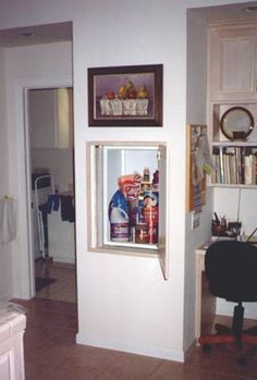 an open refrigerator in the corner of a kitchen