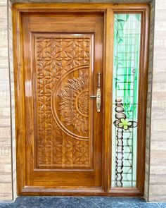 a wooden door with decorative glass on it