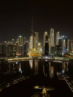 the city skyline is lit up at night