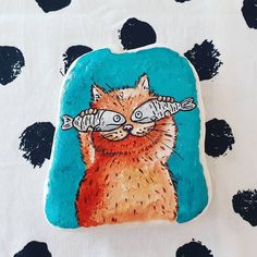 a painting of a cat with glasses on it's eyes and some fish in its mouth