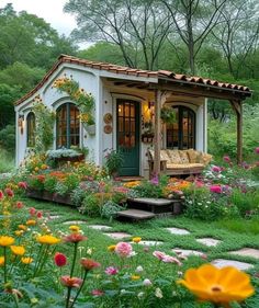 a small house with flowers in the front yard