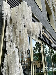 a storefront with white icing hanging from it's windows