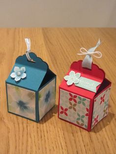 two small boxes sitting on top of a wooden table