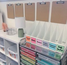 a white desk with lots of drawers and labels on it