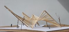 three wooden sculptures sitting on top of a white table next to each other and one is made out of wood