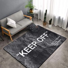 a rug with the words keep off on it in front of a couch and chair