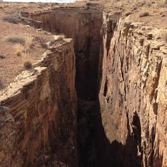 an open pit in the middle of a desert