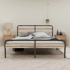 a bed sitting on top of a wooden floor next to a night stand