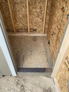 the inside of a house being built with plywood boards and studs on the walls